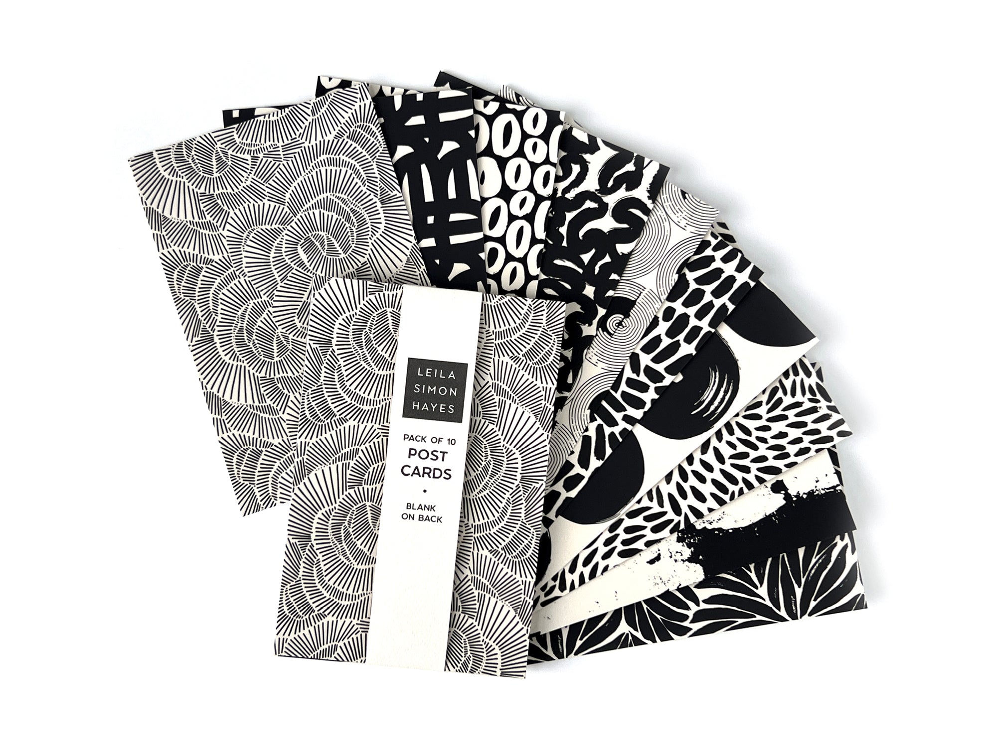 Pack of 10 black and white patterned postcards on a white background. Designed by artist Leila Simon Hayes.