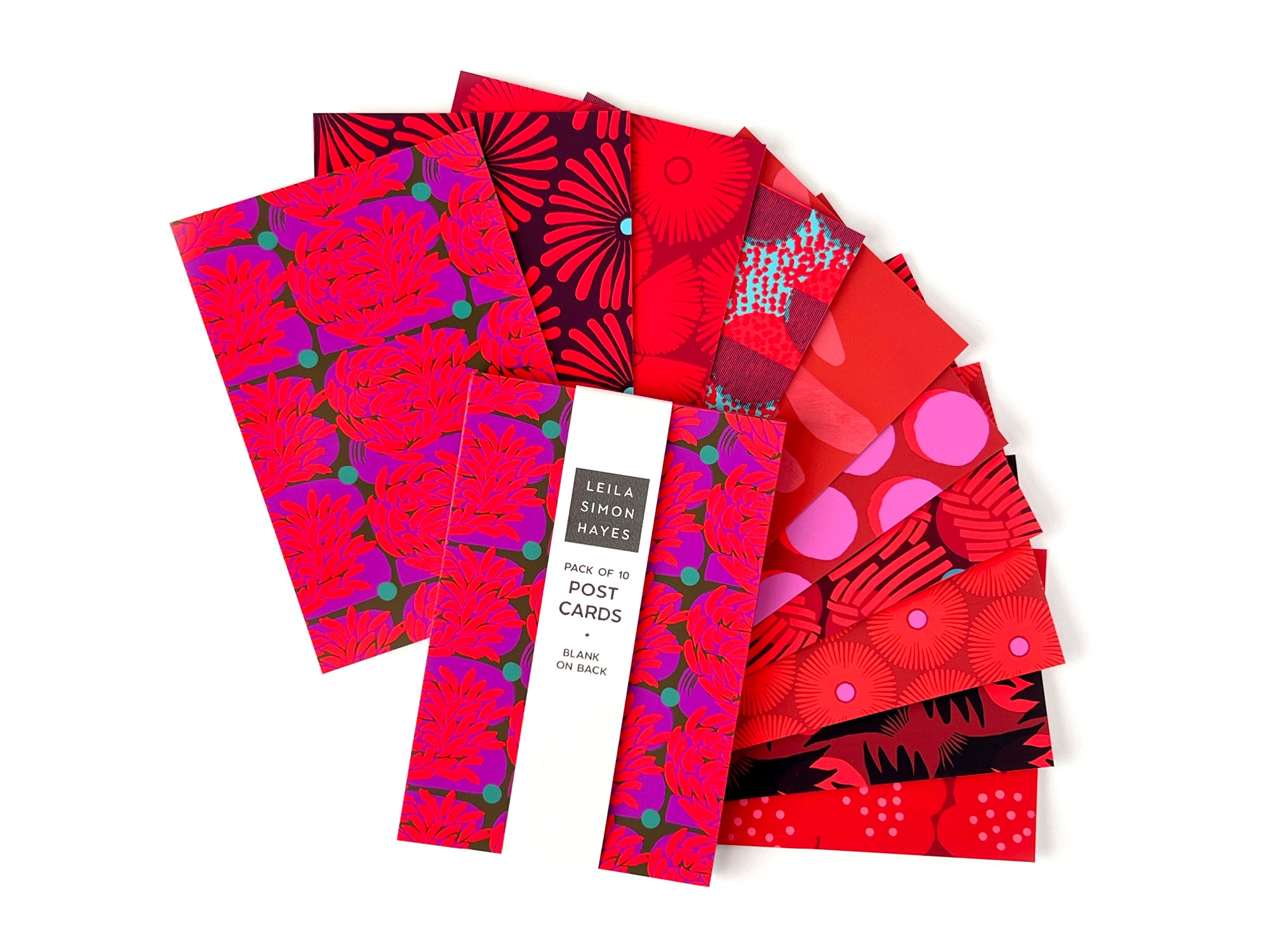 Pack of 10 colorful, red-themed greeting cards with various designs on the front and a blank back for writing. Designed by artist Leila Simon Hayes.